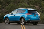 Picture of a driving 2016 Toyota RAV4 Hybrid Limited AWD in Electric Storm Blue from a rear left three-quarter perspective