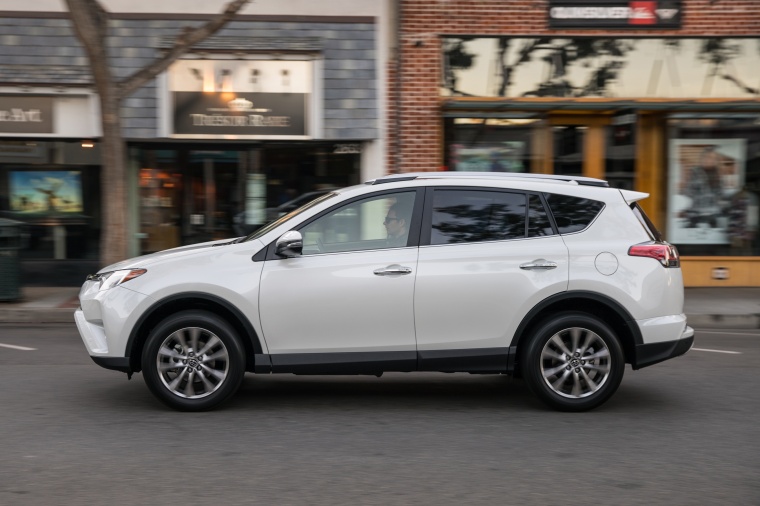 Picture of a driving 2017 Toyota RAV4 Limited AWD in Super White from a left side perspective