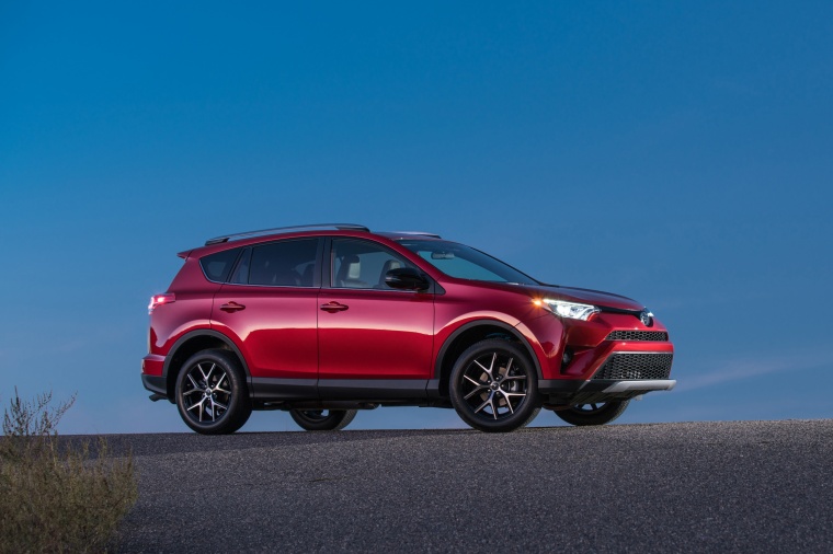 Picture of a driving 2017 Toyota RAV4 SE AWD in Barcelona Red from a front right three-quarter perspective