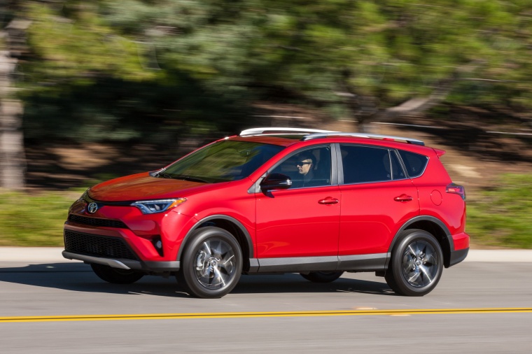 Picture of a driving 2017 Toyota RAV4 SE AWD in Barcelona Red from a front left three-quarter perspective