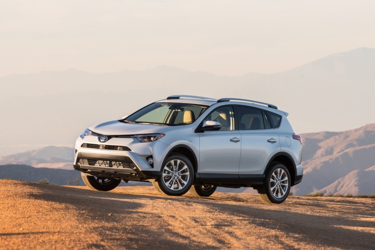 Picture of a driving 2017 Toyota RAV4 Limited AWD in Super White from a front left three-quarter perspective
