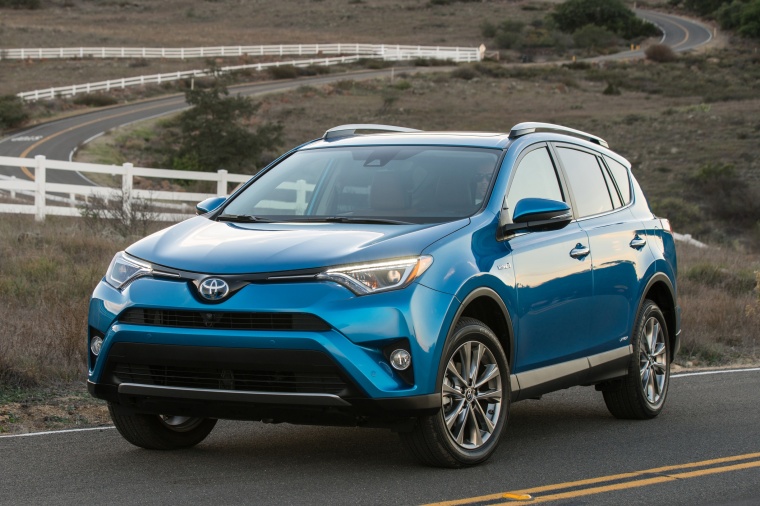 Picture of a driving 2017 Toyota RAV4 Hybrid Limited AWD in Electric Storm Blue from a front left perspective