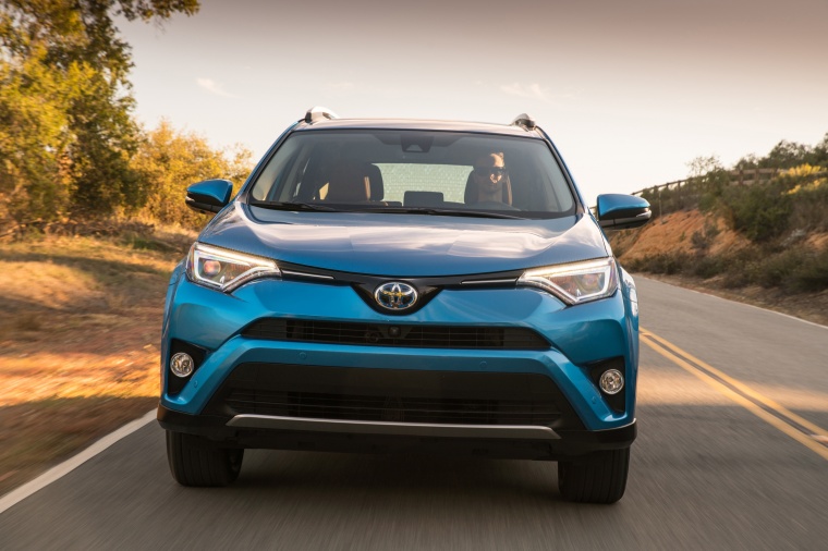 Picture of a driving 2017 Toyota RAV4 Hybrid Limited AWD in Electric Storm Blue from a frontal perspective
