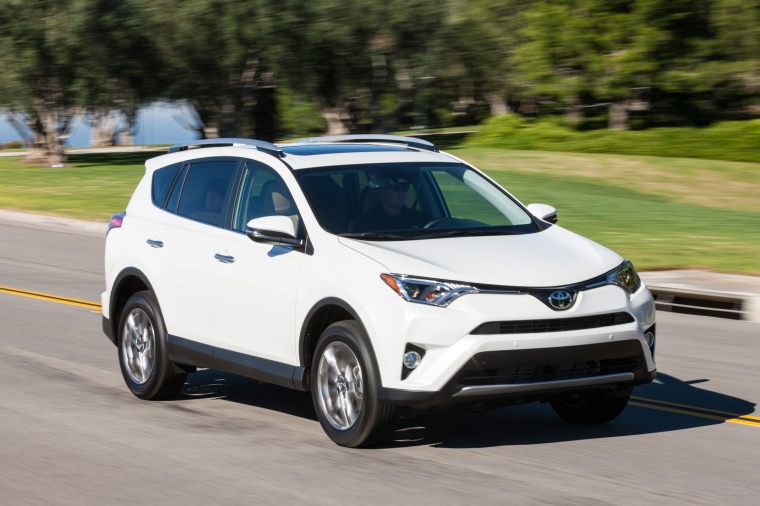 Picture of a driving 2017 Toyota RAV4 Limited AWD in Super White from a front right three-quarter perspective