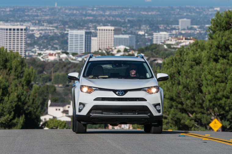 Picture of a driving 2017 Toyota RAV4 Limited AWD in Super White from a frontal perspective