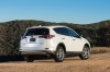 Picture of a driving 2017 Toyota RAV4 Limited AWD in Super White from a rear right three-quarter perspective