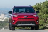 Picture of a driving 2017 Toyota RAV4 SE AWD in Barcelona Red from a frontal perspective