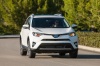 Picture of a driving 2017 Toyota RAV4 Hybrid XLE AWD in Super White from a front right perspective