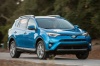Picture of a driving 2017 Toyota RAV4 Hybrid Limited AWD in Electric Storm Blue from a front right three-quarter perspective