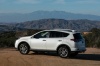 Picture of a driving 2017 Toyota RAV4 Limited AWD in Super White from a rear left three-quarter perspective