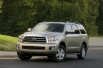 Picture of a driving 2016 Toyota Sequoia in Sandy Beach Metallic from a front left three-quarter perspective
