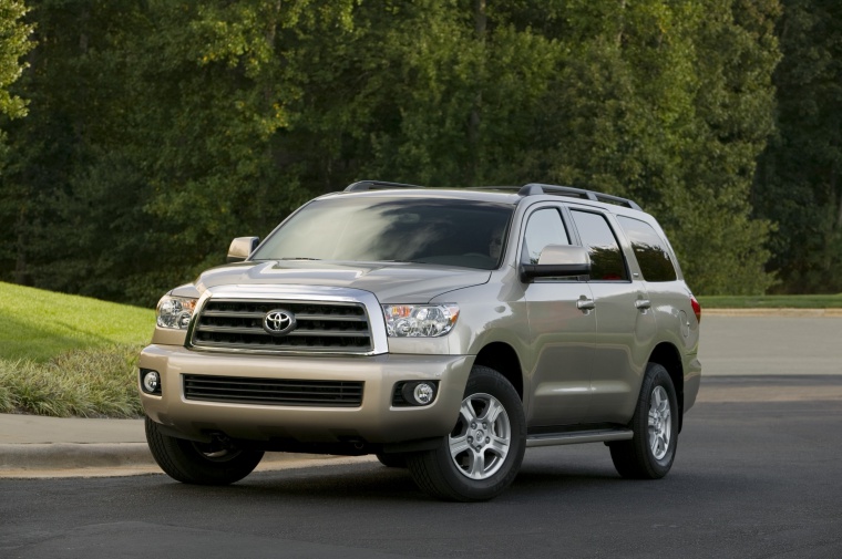 Picture of a driving 2017 Toyota Sequoia in Sandy Beach Metallic from a front left three-quarter perspective