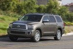 Picture of a driving 2017 Toyota Sequoia in Pyrite Mica from a front left three-quarter perspective