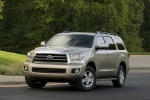 Picture of a driving 2017 Toyota Sequoia in Sandy Beach Metallic from a front left three-quarter perspective