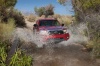 Picture of a driving 2014 Toyota Tacoma Access Cab V6 4WD in Barcelona Red Metallic from a front right perspective
