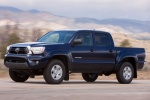 Picture of a driving 2014 Toyota Tacoma Double Cab SR5 V6 4WD in Blue Ribbon Metallic from a front left three-quarter perspective