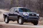Picture of a driving 2014 Toyota Tacoma Double Cab SR5 V6 4WD in Blue Ribbon Metallic from a front right three-quarter perspective
