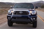 Picture of a driving 2014 Toyota Tacoma Double Cab SR5 V6 4WD in Blue Ribbon Metallic from a frontal perspective