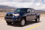 Picture of a driving 2014 Toyota Tacoma Double Cab SR5 V6 4WD in Blue Ribbon Metallic from a front left perspective