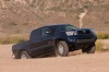 Picture of a driving 2015 Toyota Tacoma Double Cab SR5 V6 4WD in Blue Ribbon Metallic from a front right perspective