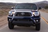 Picture of a driving 2015 Toyota Tacoma Double Cab SR5 V6 4WD in Blue Ribbon Metallic from a frontal perspective