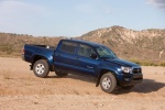 Picture of a driving 2015 Toyota Tacoma Double Cab SR5 V6 4WD in Blue Ribbon Metallic from a front right three-quarter perspective