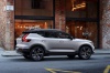 Picture of a driving 2019 Volvo XC40 T5 R-Design AWD in Crystal White Metallic from a right side perspective