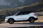 Picture of a driving 2019 Volvo XC40 T5 R-Design AWD in Crystal White Metallic from a left side perspective