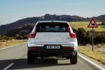 Picture of a driving 2019 Volvo XC40 T5 R-Design AWD in Crystal White Metallic from a rear perspective